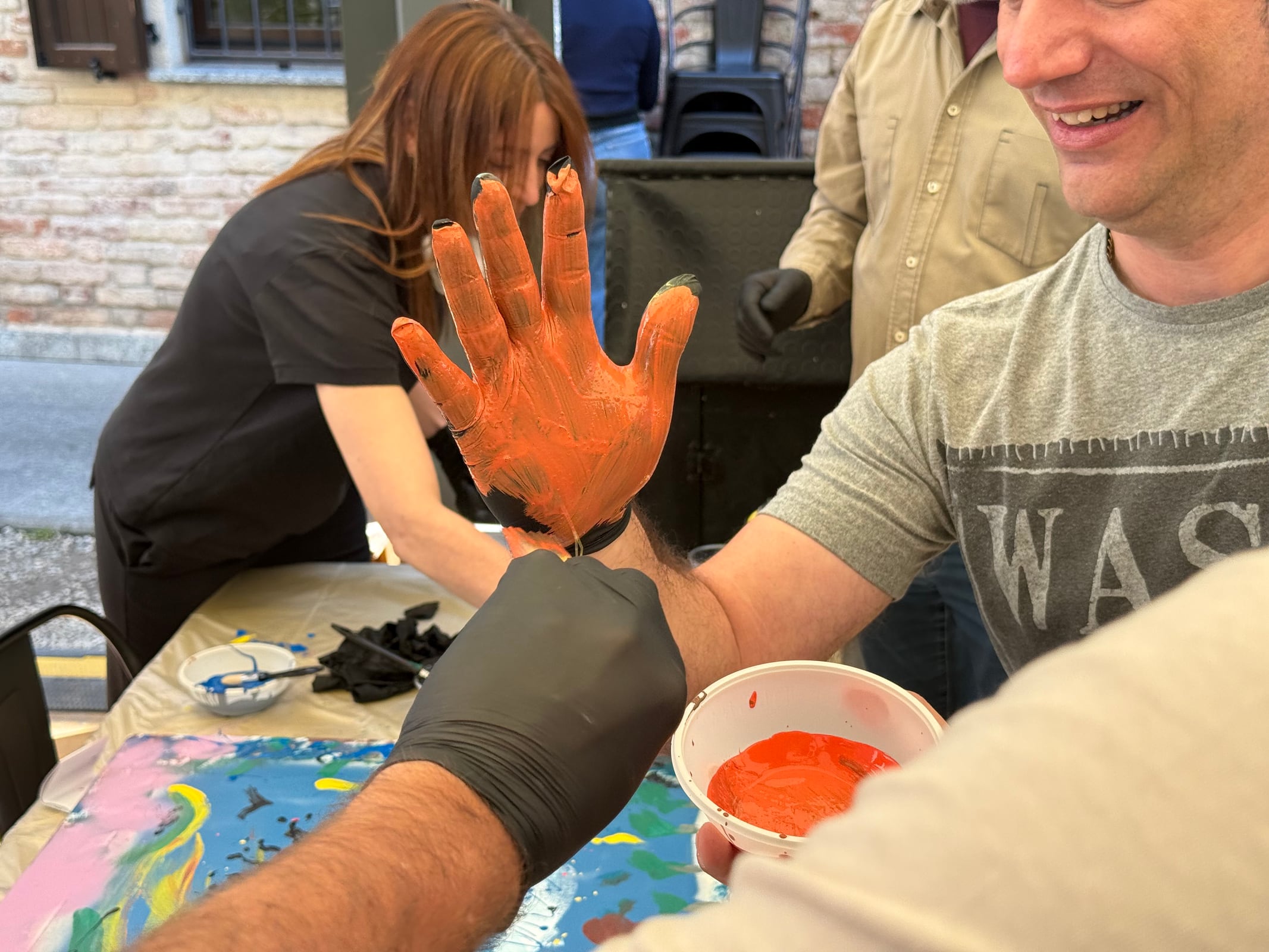 Participants painting by hand during the street art team workshop.