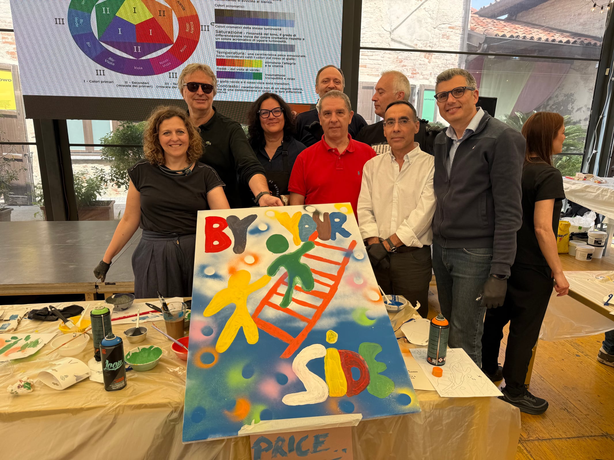 Participants presenting a colourful artwork created during the workshop.