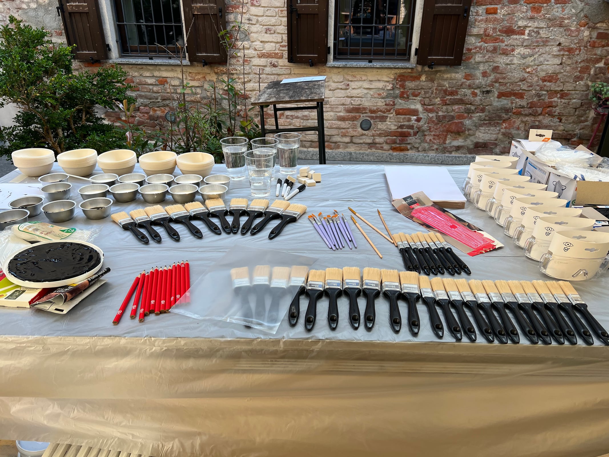 Workshop materials arranged on a long table before the activity starts.